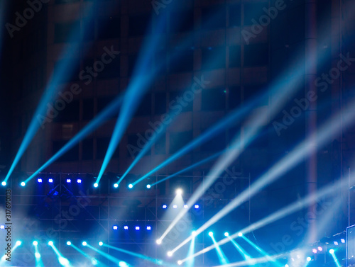 multiple spotlights on a theatre stage lighting rig