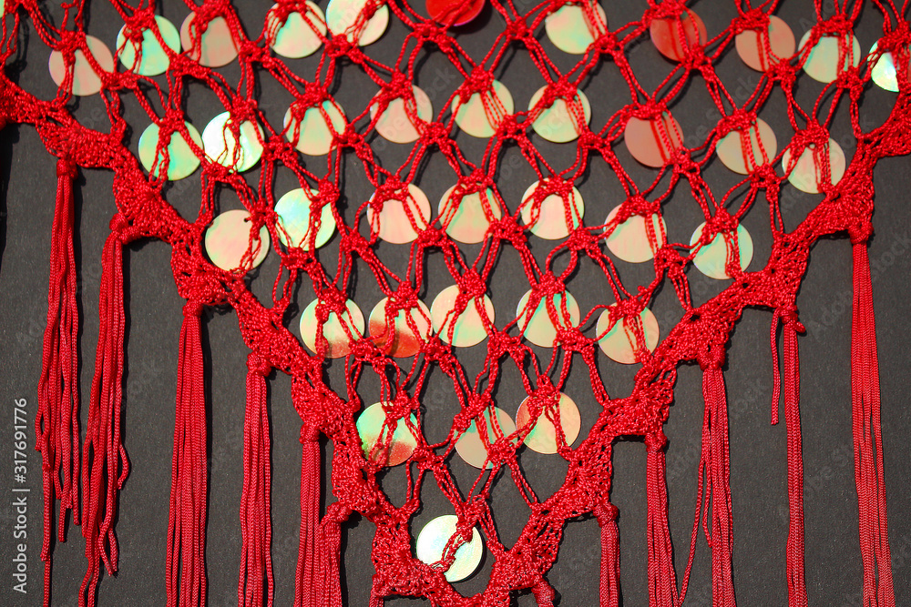Obraz na plátně Plenty of shinny, bright little red circles on transparent red scarf on black background