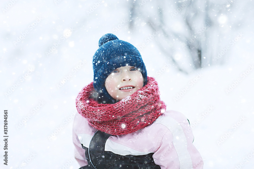 cheerful happy little girl on winter walk / little girl smiles and laughs in snow, plays winter for a walk. The concept of happy childhood. Warm sportswear down jacket, mittens, children's shoes cheerful happy little girl on winter walk / little girl smiles and laughs in snow, plays winter for a walk. The concept of happy childhood. Warm sportswear down jacket, mittens, children's shoes