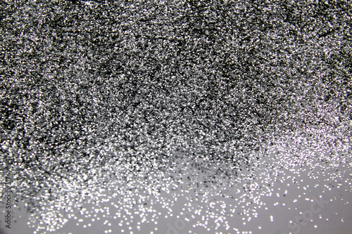 A composition with beautiful silver glitter. Background and texture of silver glitter. Luxury silver glitter sparkle shining texture background