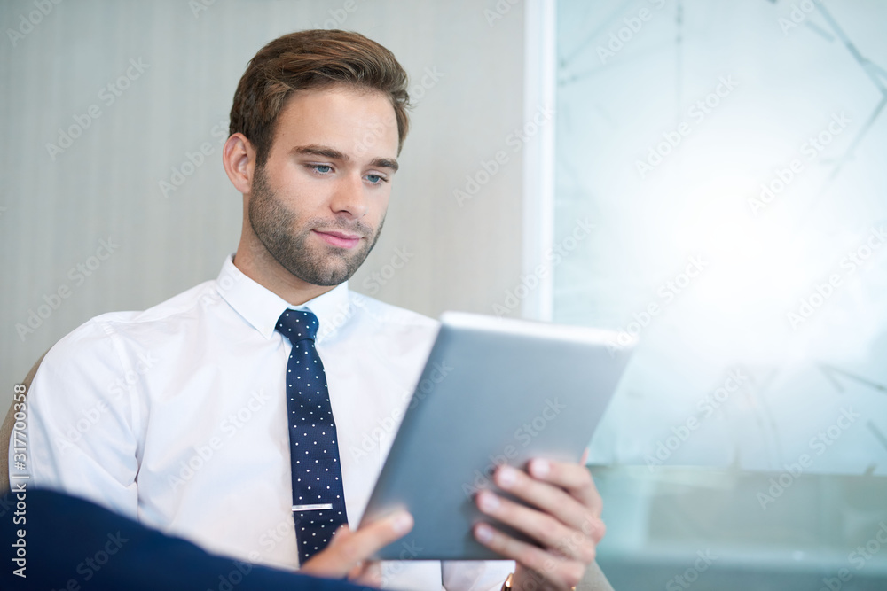 Stylish young business executive using a digital tablet Stylish young business executive using a digital tablet