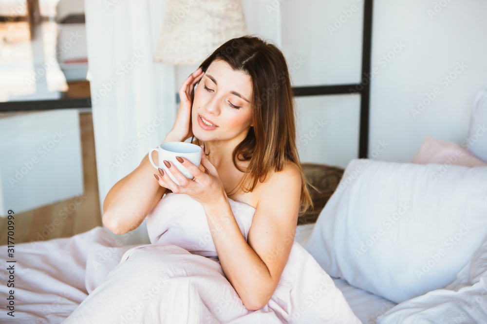 Woman woke up in bed. Woman drinking coffee in bed Woman woke up in bed. Woman drinking coffee in bed