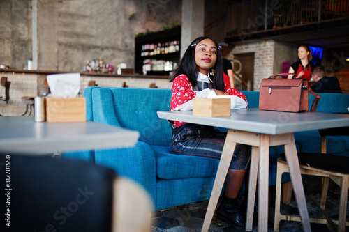 Сonfident young african american woman in smart casual wear at cafe. © AS Photo Family