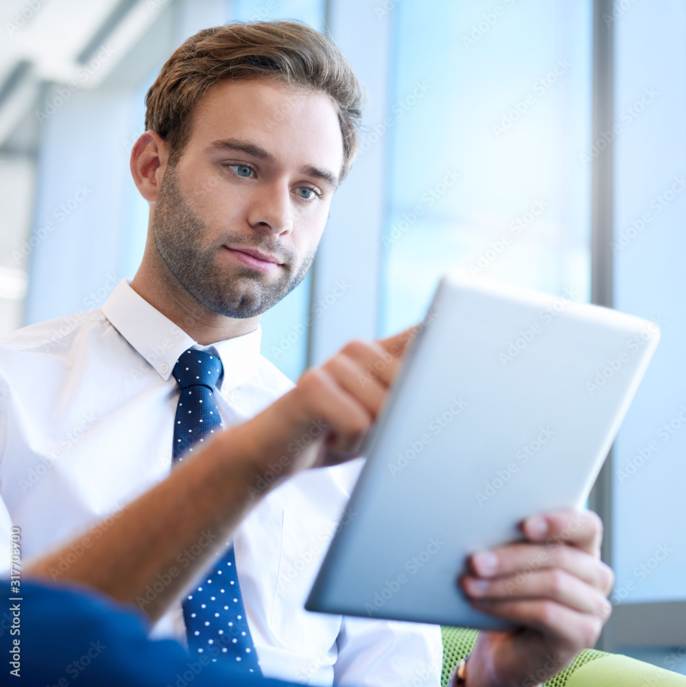 Modern young businessman using a digital tablet Modern young businessman using a digital tablet