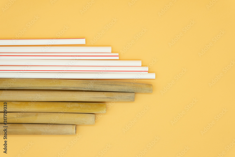 Top view. Eco friendly reusable bamboo straws and plastic straws. Zero waste concept. Top view. Eco friendly reusable bamboo straws and plastic straws. Zero waste concept.