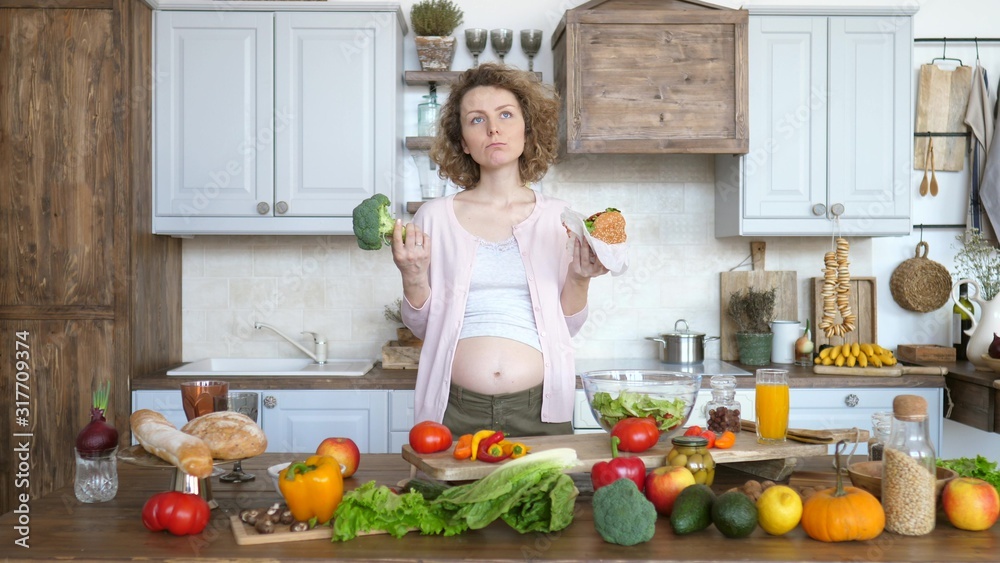 Pregnant Woman Thinking What To Eat - Burger Or Broccoli