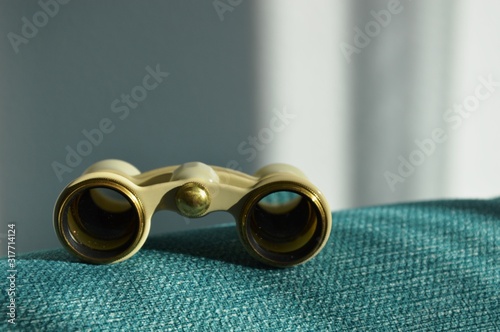 Opera glasses. Theater binoculars on a turquoise background. Vintage