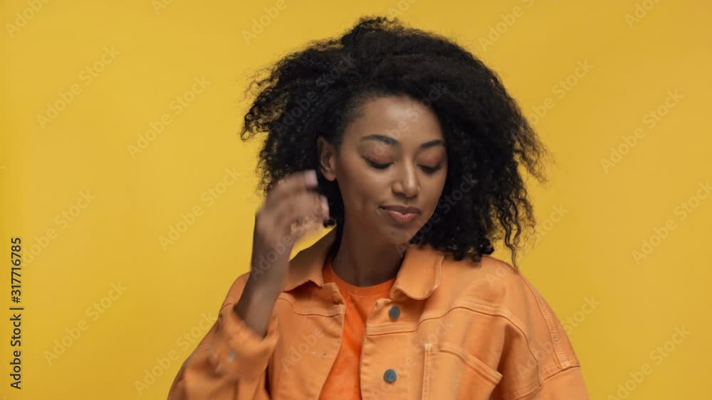 smiling african american woman posing isolated on yellow smiling african american woman posing isolated on yellow