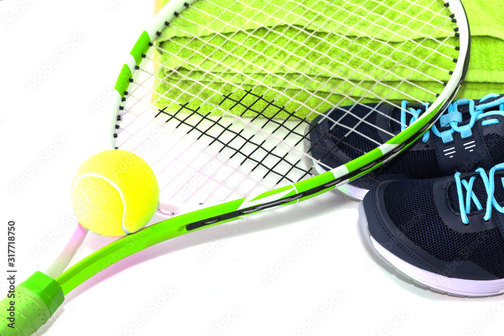 Tennis racket with a ball and sneakers, on a bright background. Photographed in the Studio.