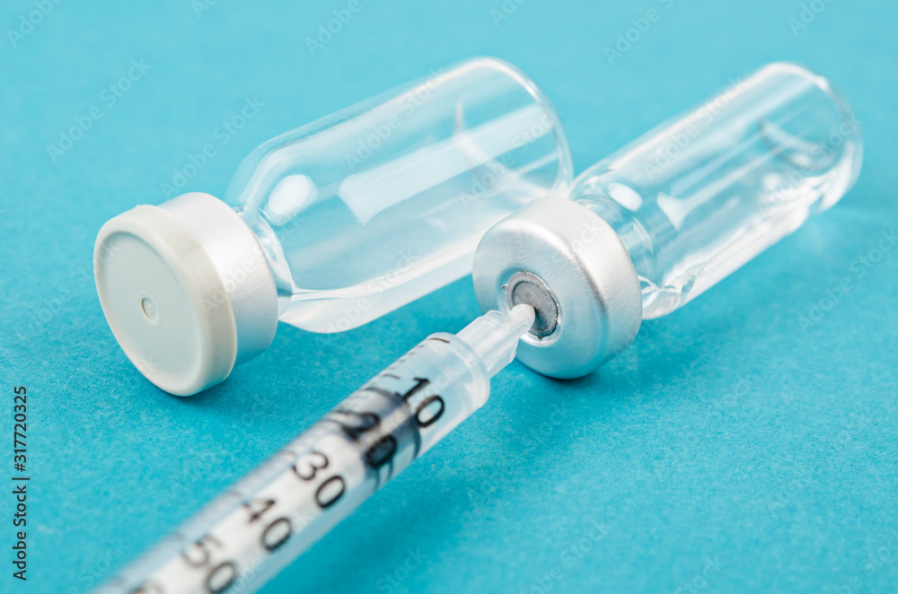 Vaccine vial dose with needle syringe, medical concept vaccination. Vaccine vial dose with needle syringe, medical concept vaccination.