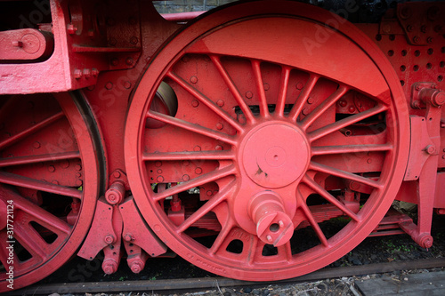 detail photo of the wheels of an antique steam locomotive