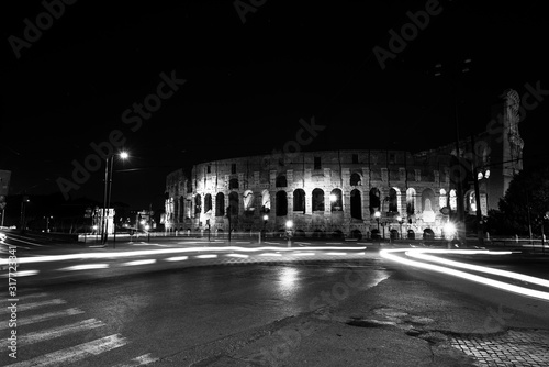 light trails from cars and buses in front of the coliseum