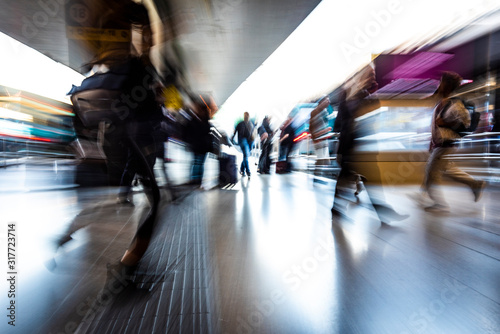 people in the station as they walk fast, blurred photo photo