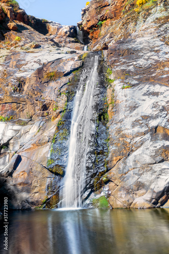Colorfull River waterfall in mountain. Waterfall mountain wall scene. Mountain waterfall view