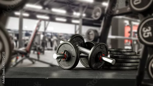 Panel kuchenny z motywem Black desk of free space for your decoration and blurred gym interior.Metal dumbbells and fit life 