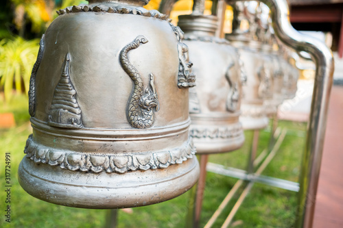 The temple bell is made of silver, carved with sacred animal images.