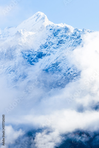 Beautiful snow-capped mountains against the blue sky © Angelov