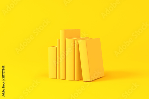 Books isolated over a yellow background. Minimalist concept.