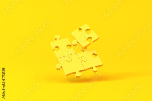 Jigsaw pieces isolated over a yellow background. Minimalist concept.