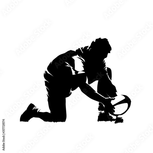 Rugby player prepares ball for penalty kick, isolated vector silhouette, ink drawing