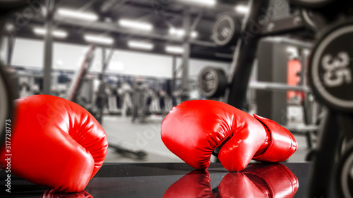 Gym interior and desk of free space.Red boxing gloves and copy space. 