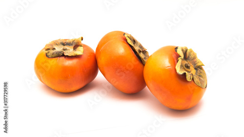 Three Fuyu persimmon isolated photo