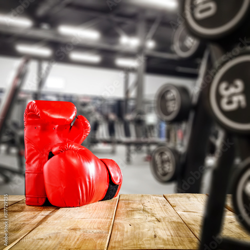 Gym interior and desk of free space.Red boxing gloves and copy space. 