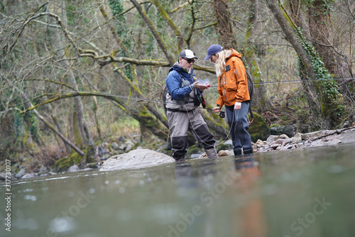 young woman learning to fly fishing with a guide