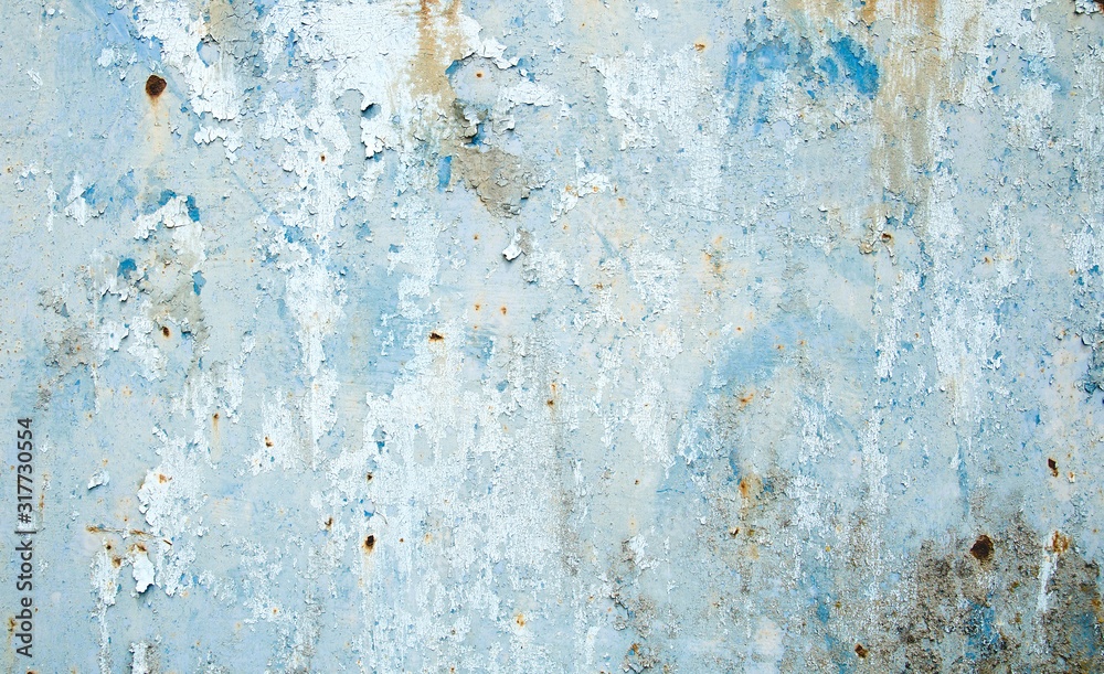 Old distressed grungy wall with blue peeling pint