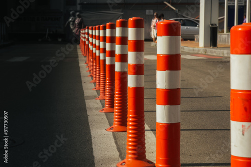 Kiev. Ukraine - 06,12,2019 A barrier made of plastic columns with reflective pigment on an asphalt road. Pillars dividing opposite lanes to ensure traffic safety. Danger concept.