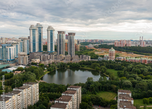 Photography Aerial view of modern skyscrapers on the lake in Moscow, beautiful nature and the roofs of houses in the frame