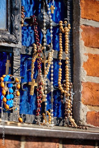 Colorful holy Marian rosaries hung at the place of the apparition in the sanctuary of the Mother of God in Gietrzwałd in Poland photo