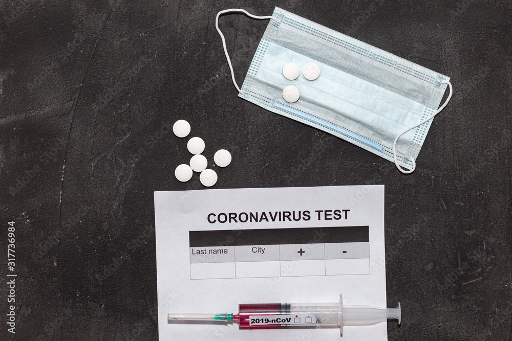 Medical form of a coronavirus test, a syringe with blood, tablets and a respiratory mask on a black background. 2019-nCoV virus originating from Wuhan, China Medical form of a coronavirus test, a syringe with blood, tablets and a respiratory mask on a black background. 2019-nCoV virus originating from Wuhan, China