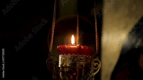 candle in a candlestick on a chain photo