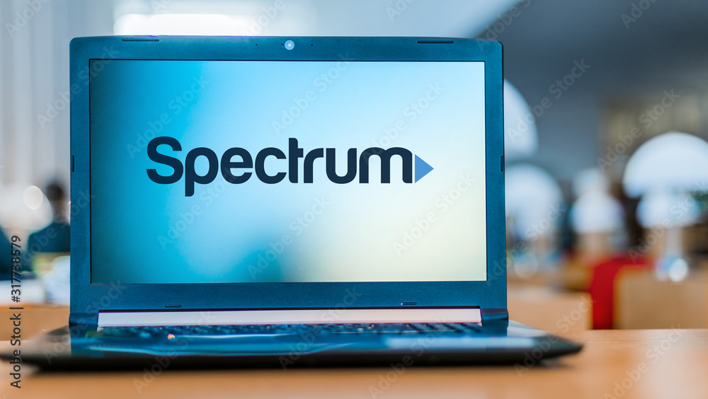 Laptop computer displaying logo of Spectrum Stock Photo | Adobe Stock