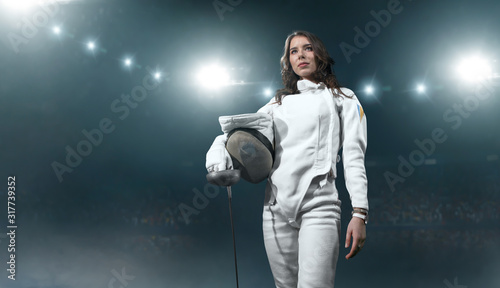 Female fencer on professional sports arena.