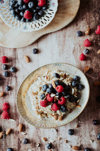 Porridge bowl, oat meal with blueberries, raspberries and almond splits