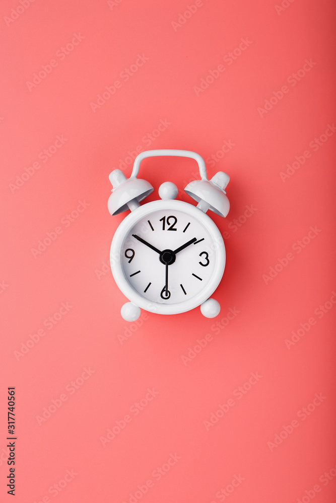 White retro alarm clock on pink background. Concept of time with free space for text. White retro alarm clock on pink background. Concept of time with free space for text.