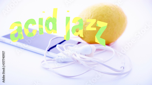 Fotografie a white portable player and white headphones lie on a white table against a brig