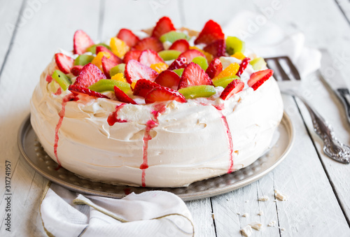 Delicious Pavlova cake with meringue and fresh strawberries photo