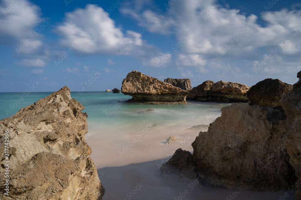 longexposure, Fazayah Beach, Salalah Oman, Fantastic seascape, great outdoor scene of Beauty of nature concept background, blue sea, few clouds, light sandy beach, rocks in the water