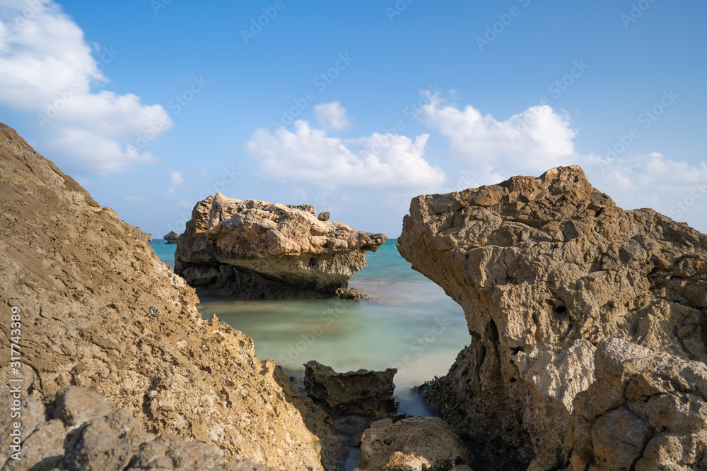 longexposure, Fazayah Beach, Salalah Oman, Fantastic seascape, great outdoor scene of Beauty of nature concept background, blue sea, few clouds, rocks in the water