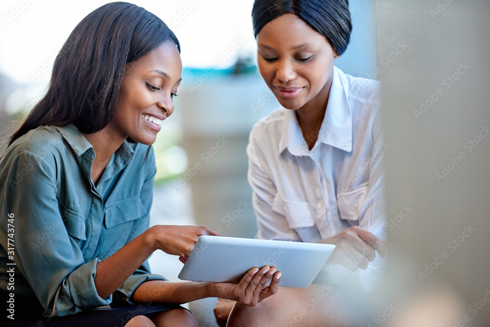 Coworkers talking digital business together in a modern office Coworkers talking digital business together in a modern office