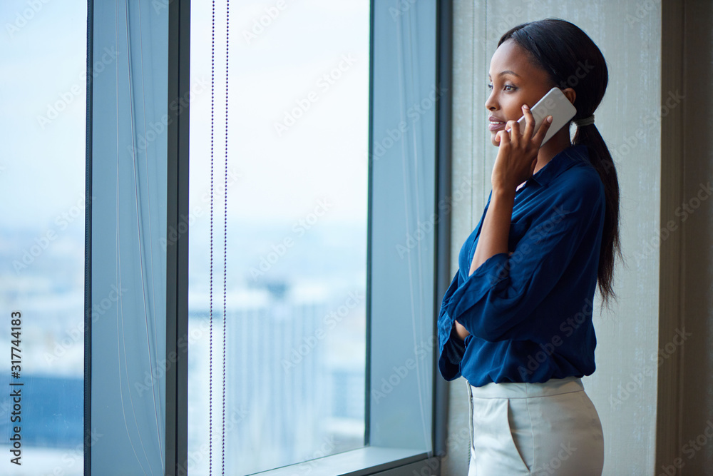 Young executive talking business with clients over the phone Young executive talking business with clients over the phone