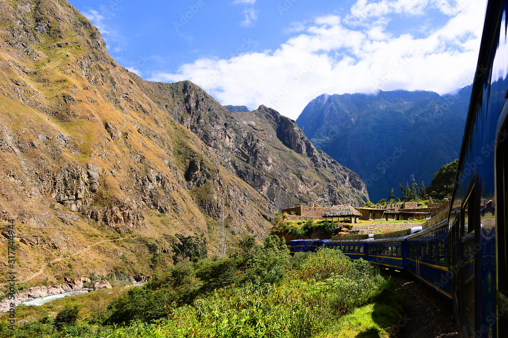 Peruvian train to Machu Picchu passes ancient buildings