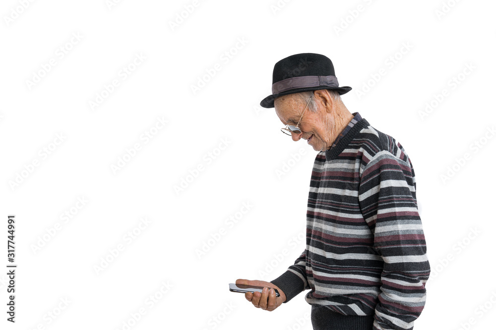 Handsome old man in casual clothes, black hat and sunglasses, senior looking attention at his smartphone to reading news, isolated over white background, copyspace Handsome old man in casual clothes, black hat and sunglasses, senior looking attention at his smartphone to reading news, isolated over white background, copyspace