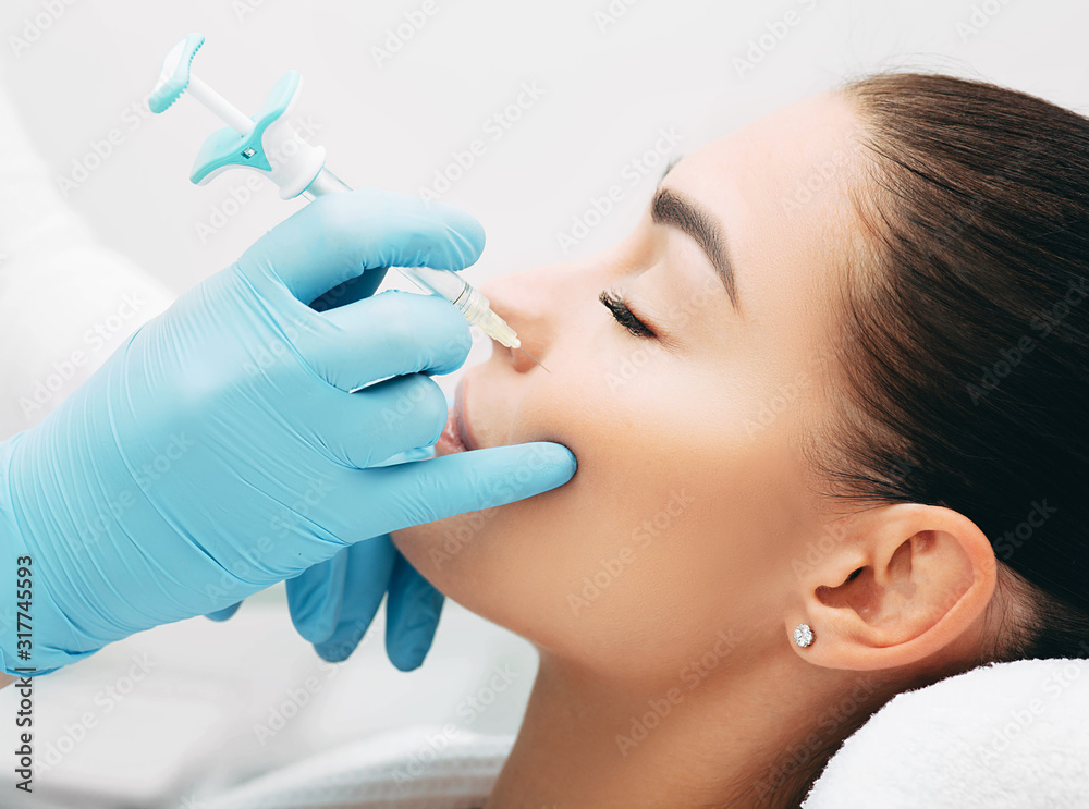 doctor injects doing injection to lift the face of a beautiful woman to get a rejuvenating effect of the skin doctor injects doing injection to lift the face of a beautiful woman to get a rejuvenating effect of the skin