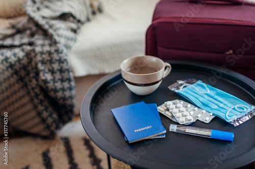 Tourism during flu epidemic in China. Passport documents, baggage and pills with medical mask for traveling