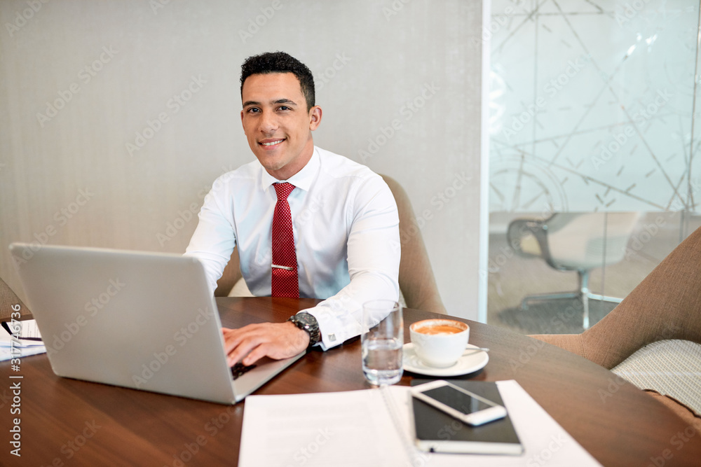 Businessman getting work done with a smile Businessman getting work done with a smile