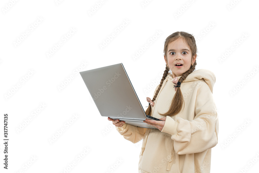 Impressed and excited young girl student with pigtails, dressed in beige hoodie holds laptop in hands and looking at the camera, isolated over white background Impressed and excited young girl student with pigtails, dressed in beige hoodie holds laptop in hands and looking at the camera, isolated over white background